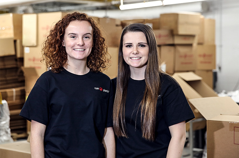Two high school students working at rose plastic USA.